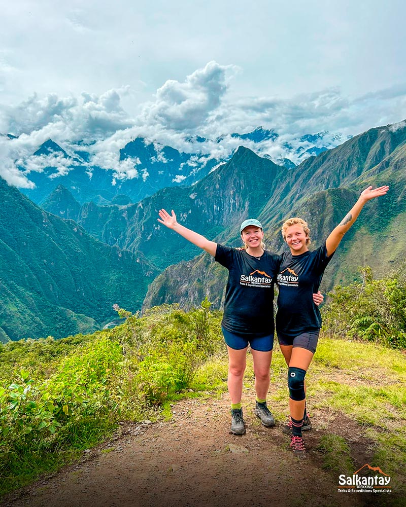 Dos turistas en el sitio arqueológico de Llactapata para tener la primera vista de Machu Picchu.