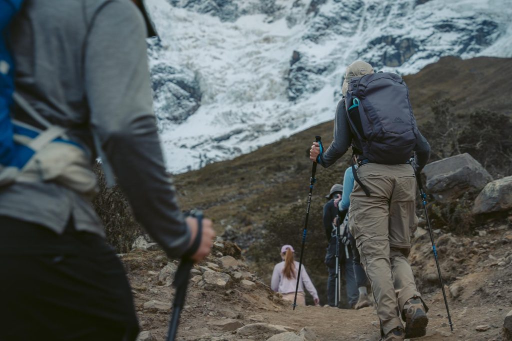 Grupo de turistas que realizan la ruta de senderismo de Salkantay con bastones de trekking adecuados.