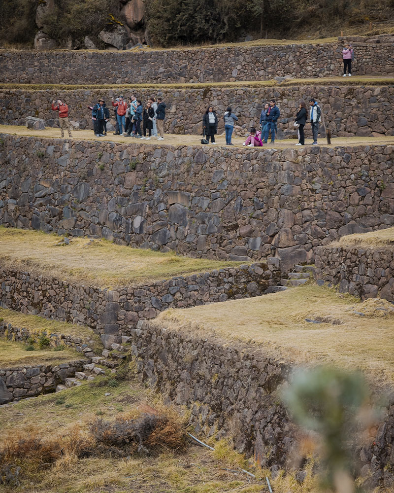 Personas en el sitio arqueológico de Pisac, Valle Sagrado, Cusco