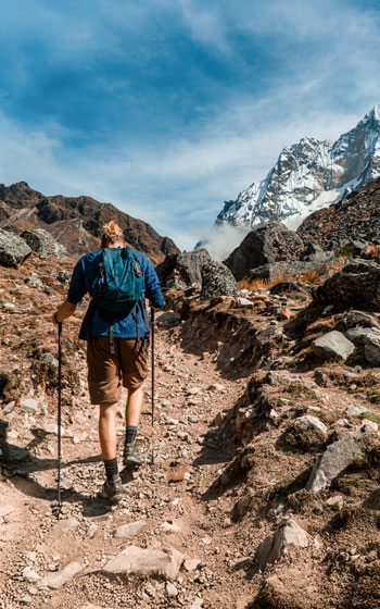 Turista caminando en el sendero de alta montaña en dirección al Paso Salkantay, el punto más alto del Salkantay Trek.