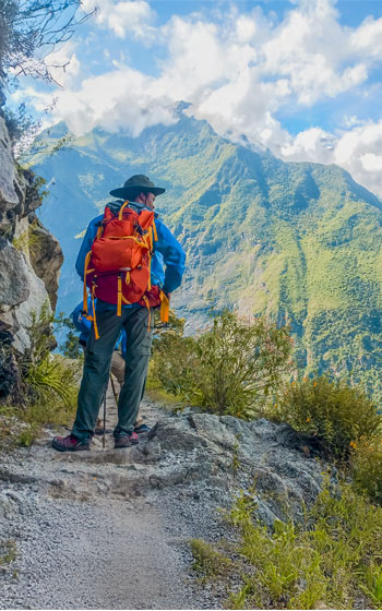 Turista disfrutando del impresionante paisaje andino mientras camina en la ruta de trekking hacia Choquequirao.