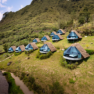 Vista de los exclusivos domos de cristal de Mountain Sky View en el campamento de Collpapampa, rodeados de vegetación tropical en el camino Salkantay.